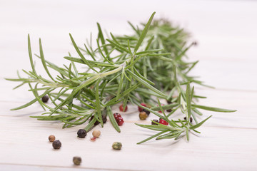 Rosemary bound with pepper and garlic on a wooden board 