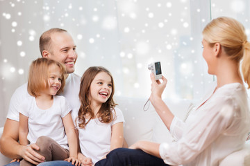 happy family with camera taking picture at home