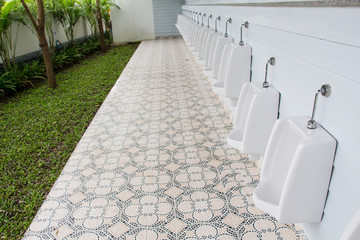 white porcelain urinals in public toilets