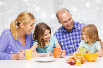 happy family with two kids having breakfast