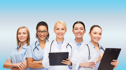 smiling female doctors and nurses with stethoscope