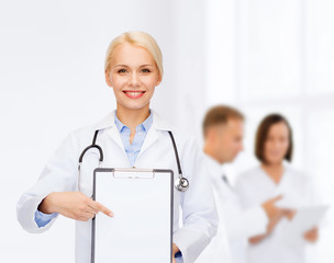 smiling female doctor with clipboard