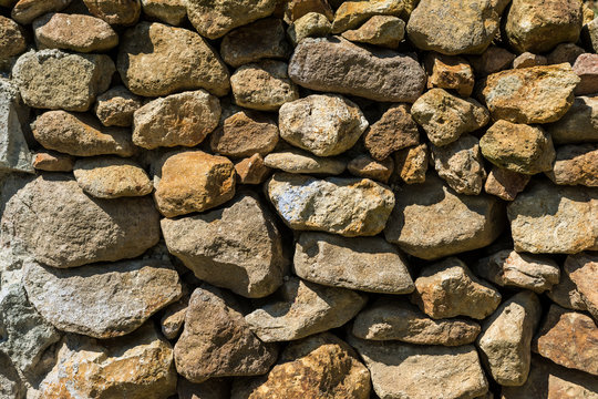 Old Stone Wall Made Of Rocks Close Up