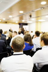 The audience listens to the acting in a conference hall