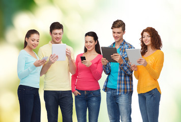 group of teenagers with smartphones and tablet pc