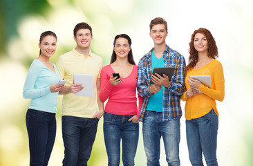 group of teenagers with smartphones and tablet pc