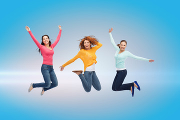 Obraz na płótnie Canvas smiling young women jumping in air