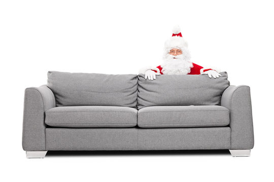 Santa Claus Hiding Behind A Sofa