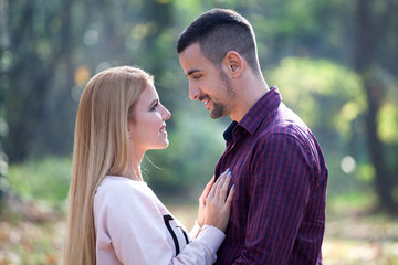 Fototapeta premium Young couple in autumn park
