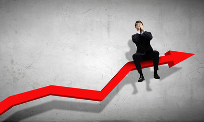 Fototapeta premium Businessman sitting on graph