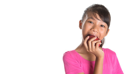 Young Asian teen eating a red apple over white background