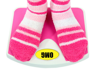 Feet on scales isolated on white