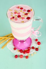 Cranberry milk dessert in glass  on color wooden background