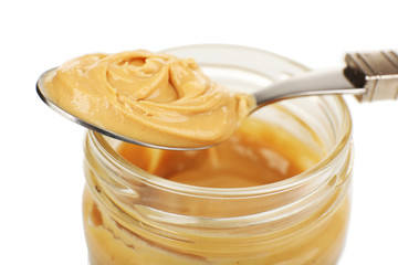 Creamy peanut butter in jar, isolated on white