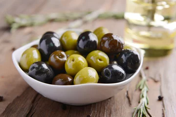 Abwaschbare Fototapete Different marinated olives on table close-up © Africa Studio