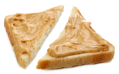 Slices of bread with creamy peanut butter, isolated on white