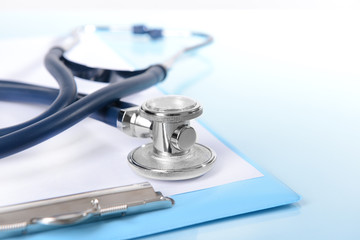 Stethoscope on light blue background
