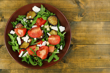 Eggplant salad with tomatoes, arugula and feta cheese,