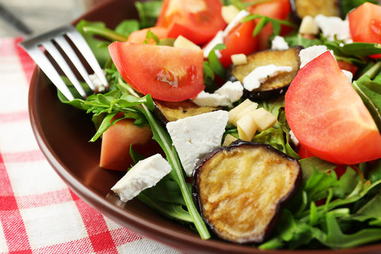 Eggplant salad with tomatoes, arugula and feta cheese,