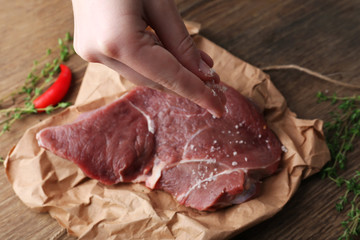 Raw beef steak on wooden table