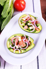 Tasty salad in avocado on plate table close-up