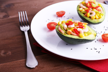 Tasty salad in avocado on plate table close-up