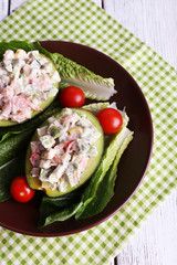 Tasty salad in avocado on plate table close-up