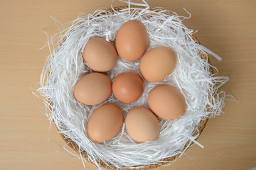 Top view of chicken eggs in wooden basket