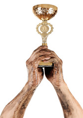 Gold cup in dirty hands isolated on white