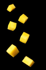 Mango slices on black background