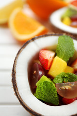 Fruit salad in coconut on table