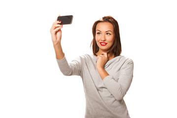 Fototapeta premium Beautiful young woman taking selfie.
