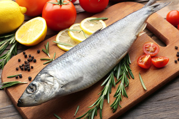 Fresh raw fish and food ingredients on table