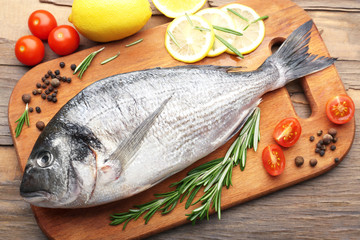 Fresh raw fish and food ingredients on table