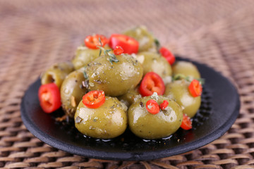 Green olives in oil with spices and rosemary