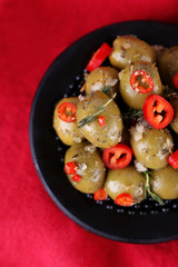 Green olives in oil with spices and rosemary