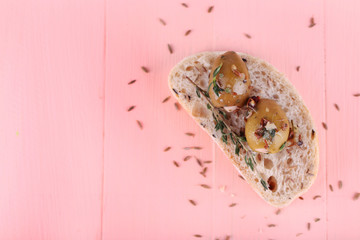 Green olives in oil with spices and bread on table close-up