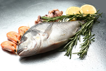 Fresh fish and other seafood with lemon close-up