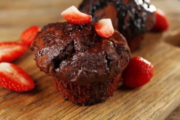 Yummy chocolate cupcake on table