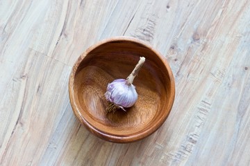 Fresh garlic in wooden bowl