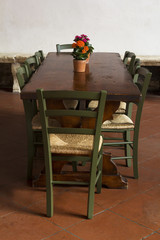 Fototapeta na wymiar Table with flowers on it in Tuscany