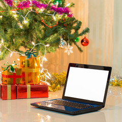 laptop with gift box and christmas lights background