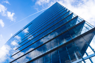 Fototapeta premium blue glass wall of skyscraper. Buildings abstract