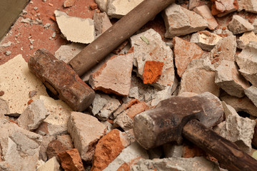 Old hammers on broken brick wall