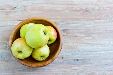 Fresh apples in wooden bowl. Horizontal image