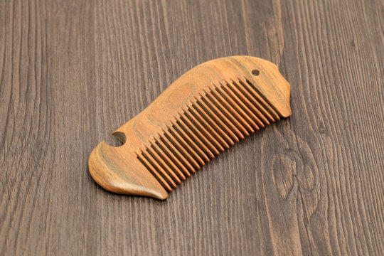 Green Sandalwood Comb On A Wood Background