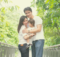 Fototapeta premium asian family enjoying outdoor park , vintage tone