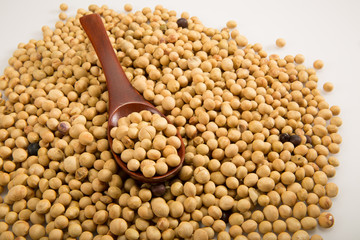 Spoonful of soy beans isolated on white background