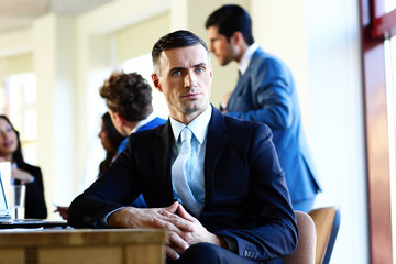 Confident businessman sitting at the table