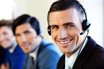 Smiling young businesspeople in a call center office